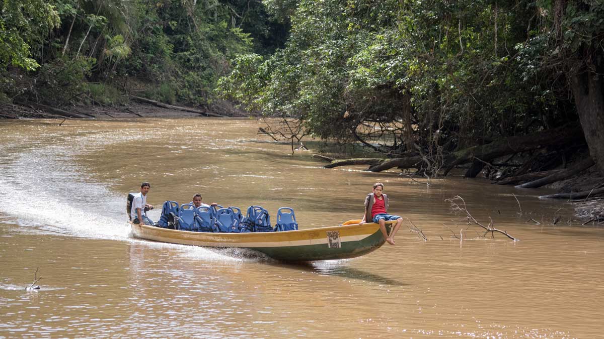 Canoe arriving from the nearby Siona Community to pick up tourists; Dracaena Lodge, Cuyabeno, Ecuador | ©Angela Drake