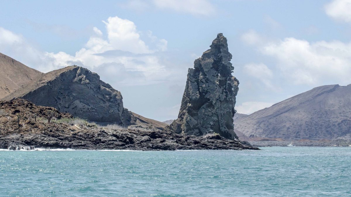Pinnacle Rock, looking from Bartolome towards Santiago Island, the Galapagos. Pinnacle Rock, looking from Bartolome towards Santiago Island, the Galapagos.