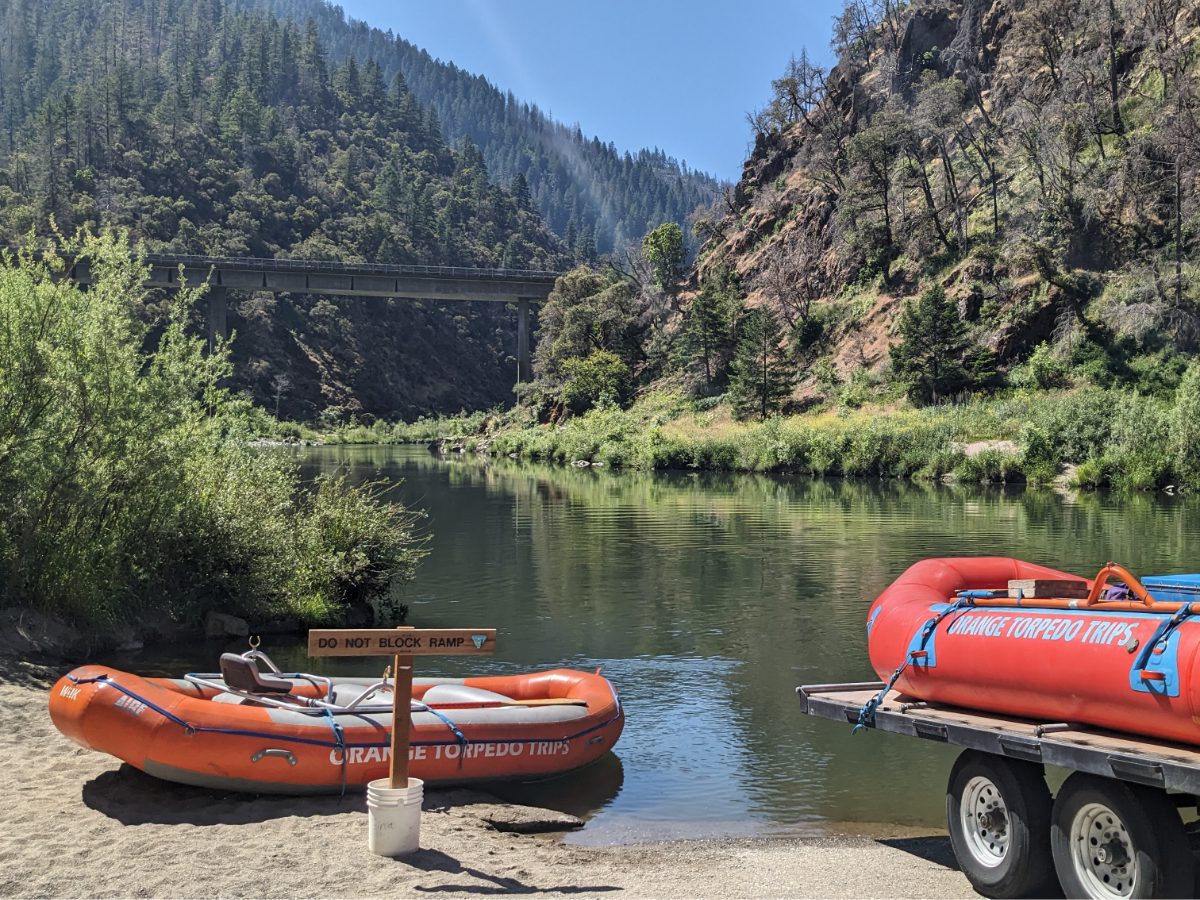 Orange Torpedo Tours rafts being off-loaded into the Rogue River at Grave Creek Boat Ramp