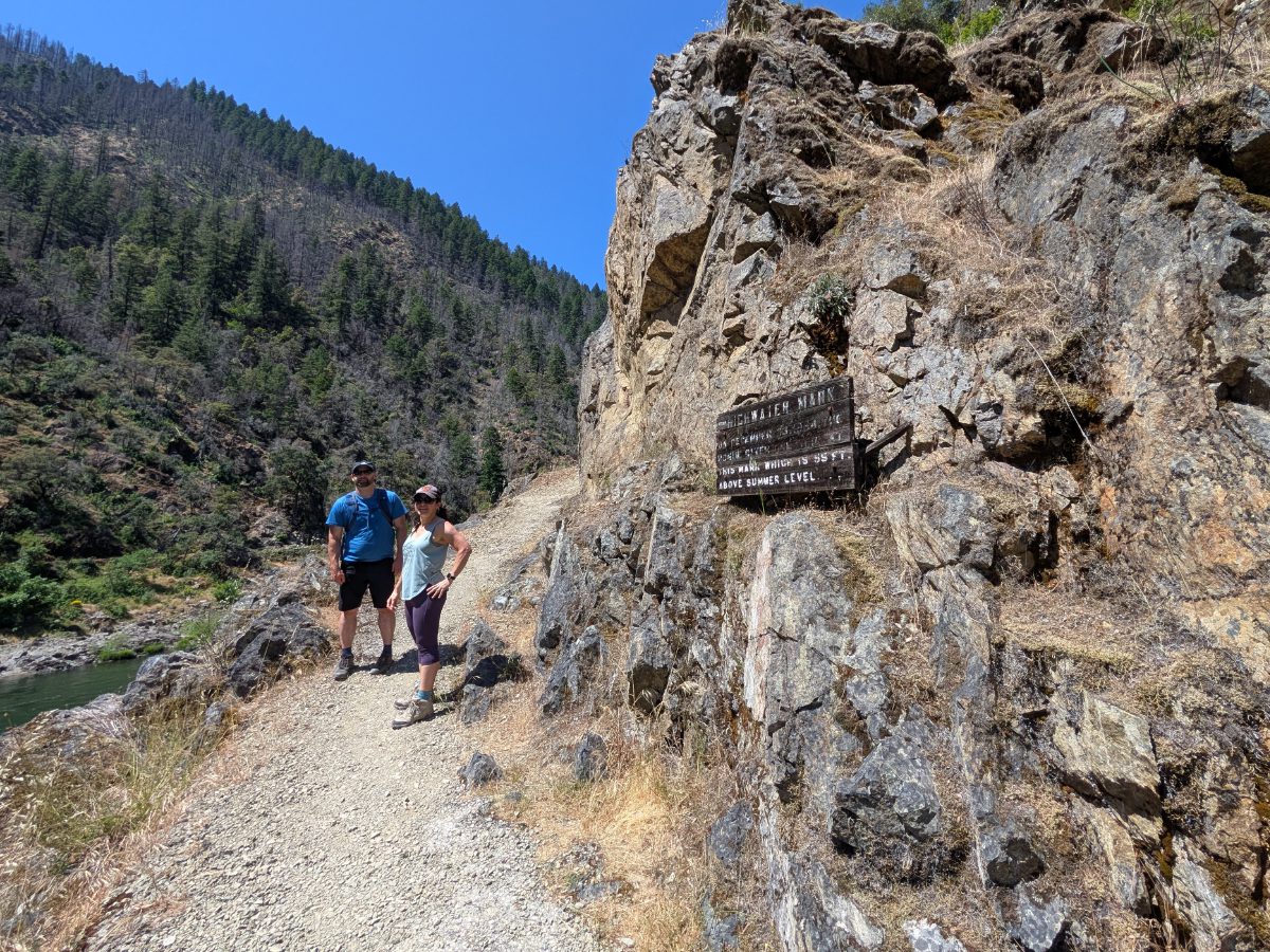 Local hikers standing near the High Water Mark sign, well above the Rogue River,  not far from Graves Creek.